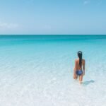 Woman walking into the ocean in South Caicos
