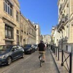 Original Photo Of Tyler Fox Editor In Chief Travel Off Path Riding bike through streets of Bordeaux France